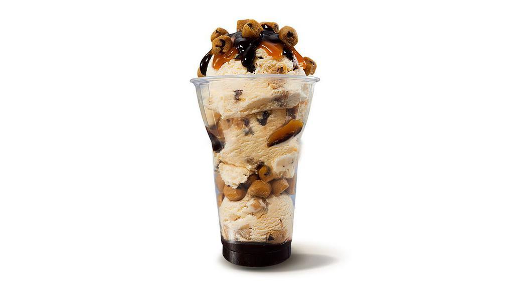 Chocolate Chip Cookie Dough Layered Sundae · Three scoops of Chocolate Chip Cookie Dough ice cream with layers of hot fudge and cookie dough pieces, topped with caramel.