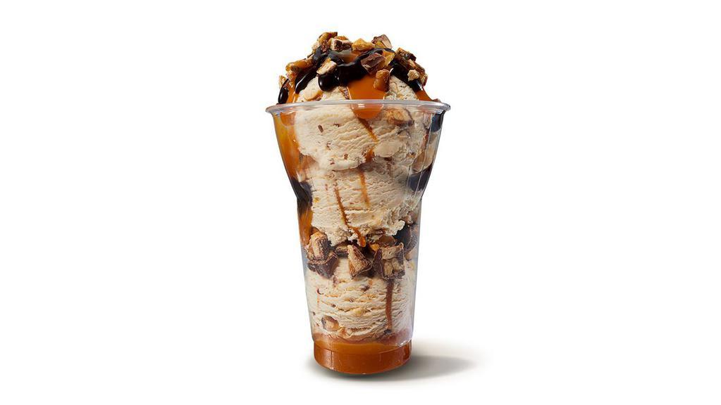 Made with SNICKERS® Layered Sundae · Three scoops of made with SNICKERS® ice cream, crushed Snickers pieces and caramel layers, topped with caramel, hot fudge, and SNICKERS® pieces.