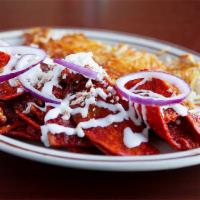 Chilaquiles · Chorizo, red sauce, corn tortilla chips, topped with 2 scrambled eggs, red onions, queso fre...