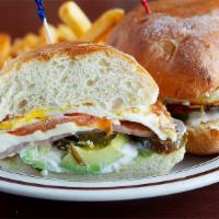 Super Torta · 2 over hard eggs, ham, tomatoes, avocado, sour cream, queso fresco and jalapenos served on a...