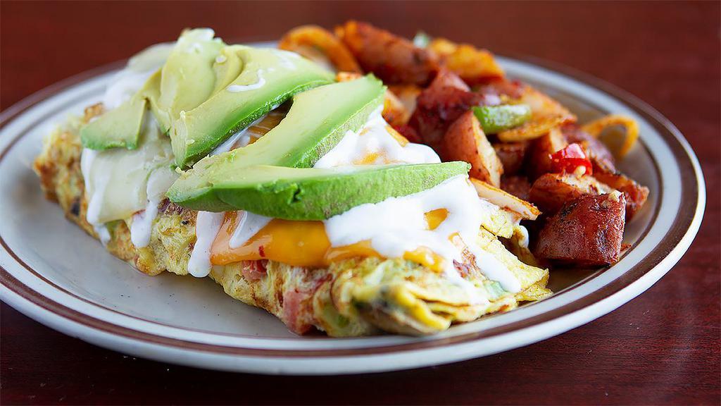 California Omelette · Bacon, mushroom, green onions, tomatoes, jack and cheddar topped with sour cream and avocado. 4 egg omelette with choice of side and toast.
