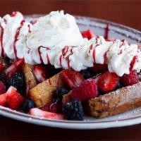 Berry Berry French Toast · Topped with blackberries, strawberries and blueberries and topped with whipped cream and ras...