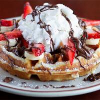 Nutella Waffle · Topped with fresh strawberry, banana, whipped cream and powdered sugar.  Batter made in hous...