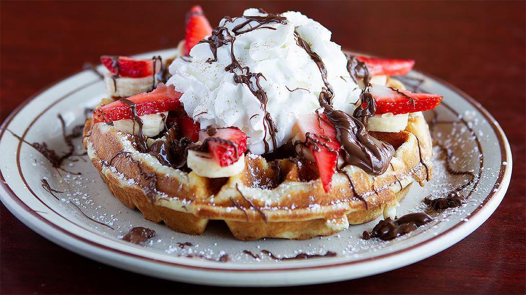 Nutella Waffle · Topped with fresh strawberry, banana, whipped cream and powdered sugar.  Batter made in house every day.