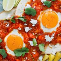 Huevos Rancheros · Sunny-side up Eggs with melted Cheese, served on top of a Tortilla with 
Potatoes a la Mexic...