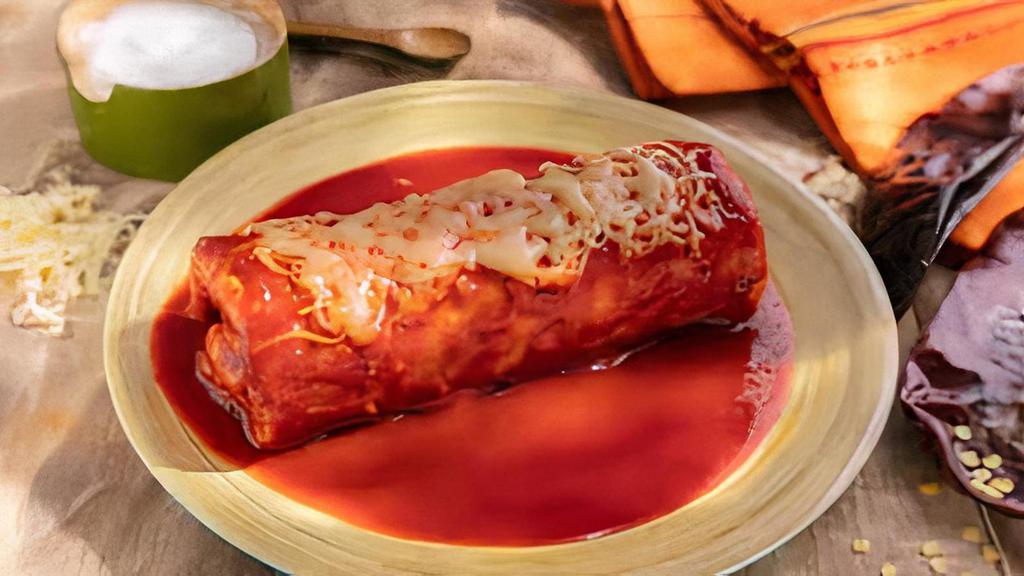 Burrito Mojado · Super Burrito topped with Arteaga’s Enchilada Sauce and melted Cheese