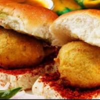 Vada Pav( 2 pc )  · Spiced potato patty flavored with ginger garlic dip in gram flour batter and deep fry . Serv...