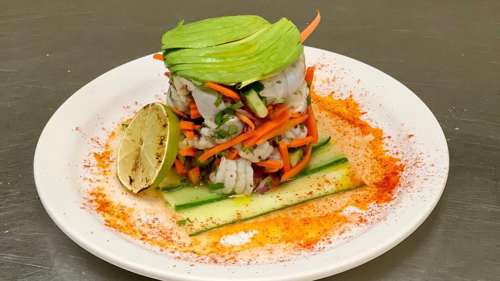 Shrimp Ceviche · Fresh shrimp marinated tossed with lime, tomatoes, carrots, cucumbers and cilantro, topped with avocado.