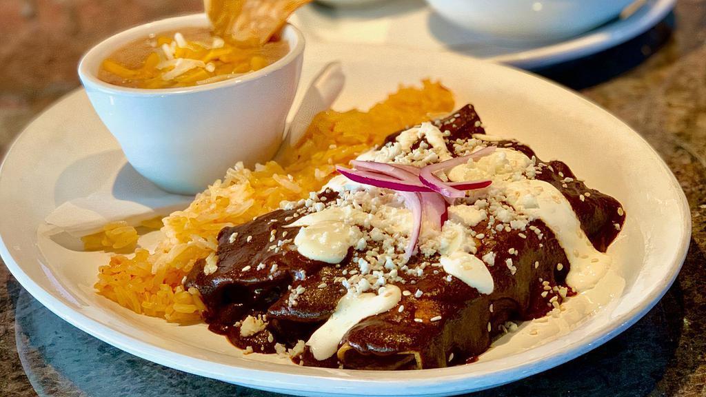 Chicken Mole · Chicken breast smothered in our house-made Mole, served with rice and charro beans.
