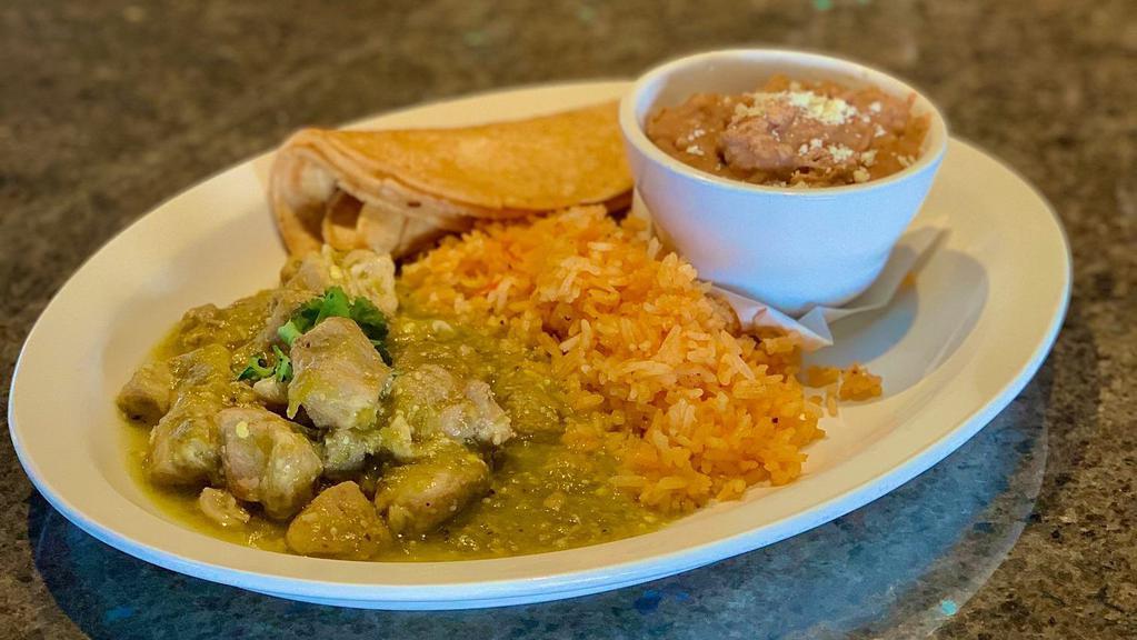 Chile Verde · Slow roasted pork tossed in our spicy and savory green sauce, served with rice and charro beans.