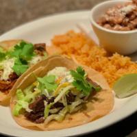 Street Tacos · Two tacos served on corn tortillas with cilantro, crema, cotija cheese, lettuce and lime. Se...