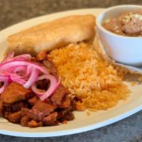 Pork Adobo · Tender chunks of pork smothered in a deep and flavorful red sauce, pickled red onions, rice ...
