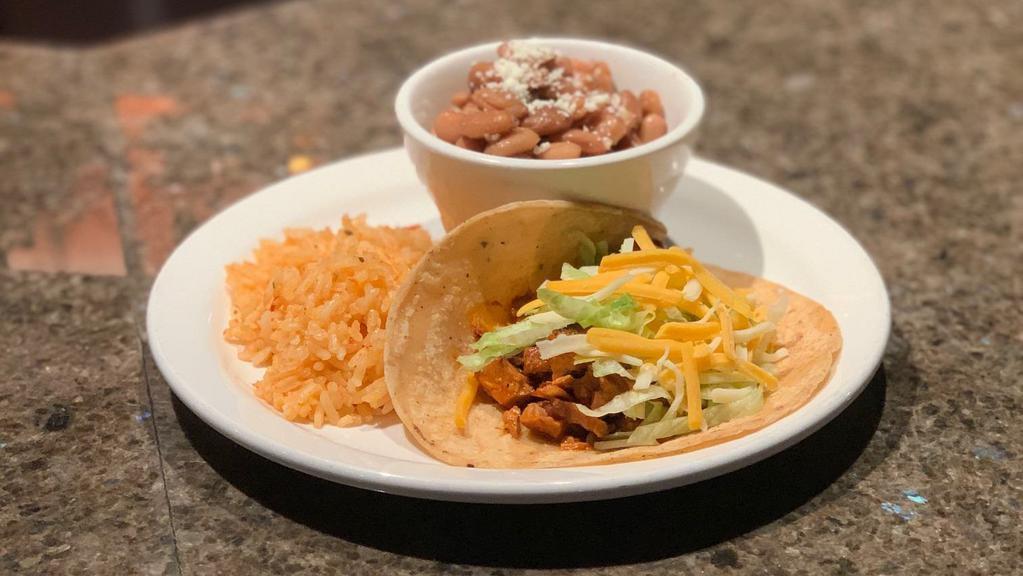 Chicken Tinga Taco · Chopped lettuce, cheese and served with rice and charro beans.