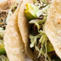 Pork Chile Verde Taco · Chopped lettuce, cheese and served with rice and charro beans.