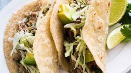 Pork Chile Verde Taco · Chopped lettuce, cheese and served with rice and charro beans.