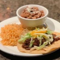 Barbacoa Taco · Chopped lettuce, cheese and served with rice and charro beans.