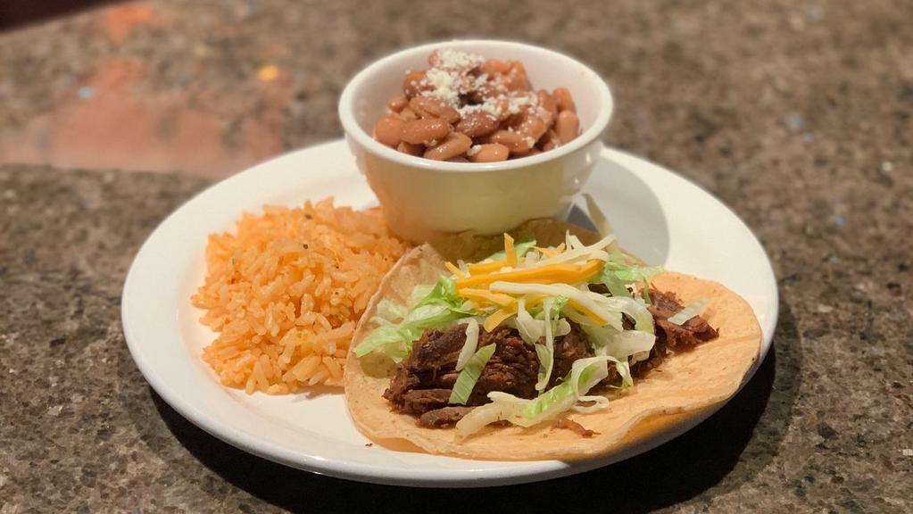 Barbacoa Taco · Chopped lettuce, cheese and served with rice and charro beans.
