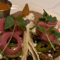 SMOKED PULLED PORK TACOS · house-made pickled onions and jalapeño, cilantro and
lime wedge