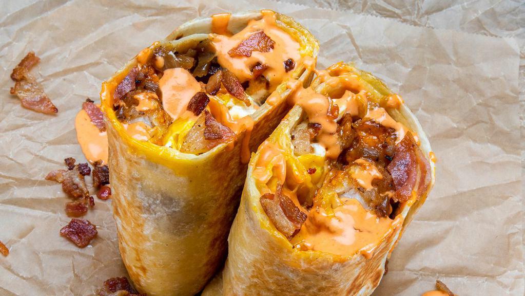 Haus Breakfast Burrito · Eggs, smoked bacon, white American cheese, crispy tater tots, caramelized onions, spicy mayo; sides of spicy mayo and hot sauce.
