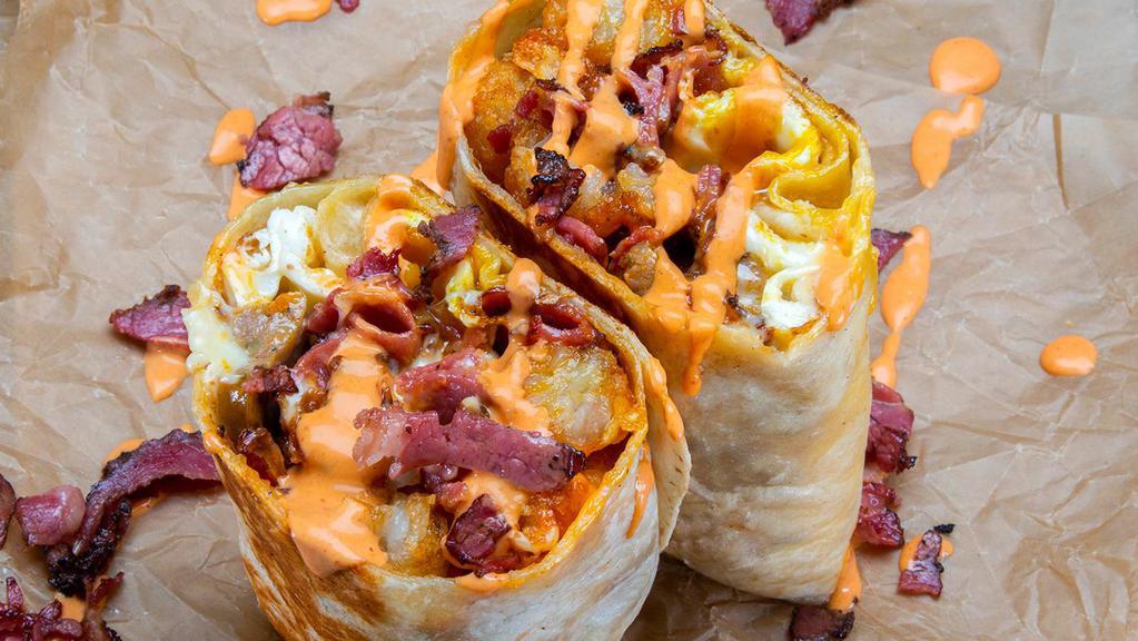 Chachi Burrito · 3 eggs, Italian sausage, pastrami, white american cheese, mozzarella cheese, crispy tater tots. Served with sides of spicy mayo & hot sauce.
