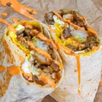 Impossible Haus Burrito · 3 eggs, Impossible breakfast sausage, white American cheese, crispy tater tots, caramelized ...