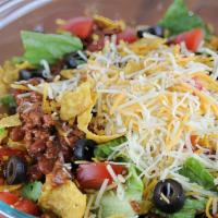Taco Salad · Seasoned ground beef, kidney, and garbanzo beans, diced tomatoes, grated cheddar cheese, bla...