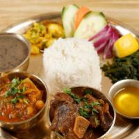 Thakali Thali Chicken · Local bone in chicken curry, raayo KO saag, kalo dal, veg of the day, rice and achar.