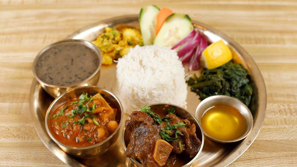Thakali Thali Goat · Goat curry, raayo KO saag, kalo dal, veg of the day, rice and achar.
