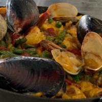 SEAFOOD PAELLA · Clams, mussels, fresh fish of the day, prawns, calamari, octopus, Spanish chorizo, sweet pea...