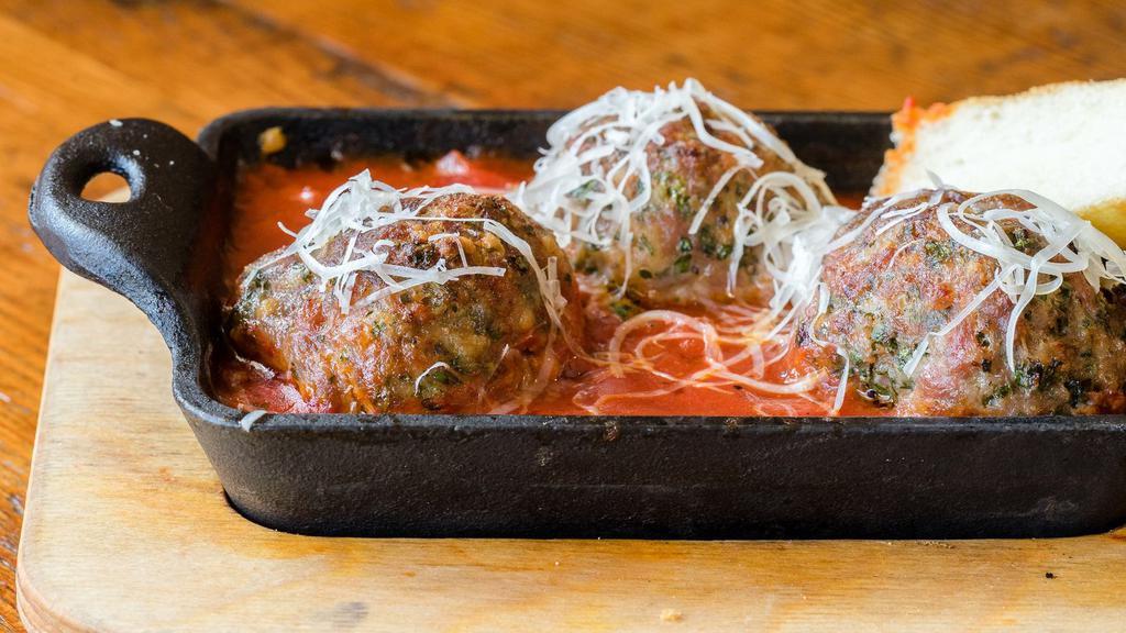 Meatballs · Three house made meatballs in marinara, garnished with aged parmesan and focaccia dipping bread