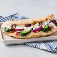 Greek Veggie Pita · Hummus, Feta cheese, red onion, cucumbers, tomatoes, tzatziki sauce on pita bread.
