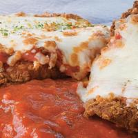 Veal Parmigiana · Breaded veal cutlet topped with marinara sauce and mozzarella, served over pasta marinara