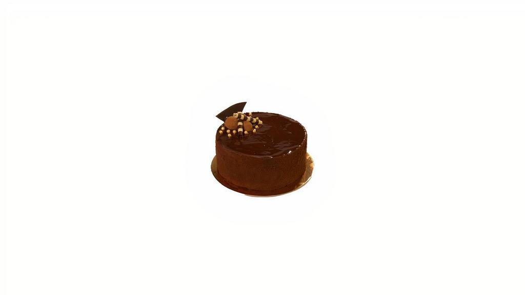 Dark Chocolate Truffle Cake · Chocolate cake with chocolate ganache filling, covered in chocolate cake crumbs, topped with chocolate glaze

6