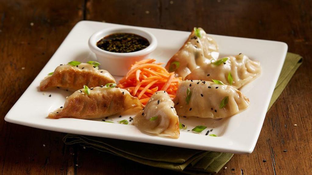 Chicken Pot Stickers · Pan-seared dumplings | chicken | ginger | garlic | yellow chives | green onions | soy ginger sauce | sesame seeds
