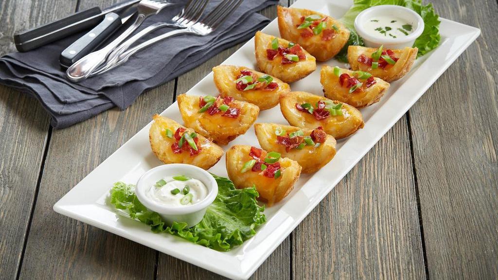 Crisp And Cheesy Potato Skins · Crisp potato skins | applewood smoked bacon | jack + cheddar cheese | housemade sriracha queso | green onions | sour cream dip and extra sriracha queso for dipping