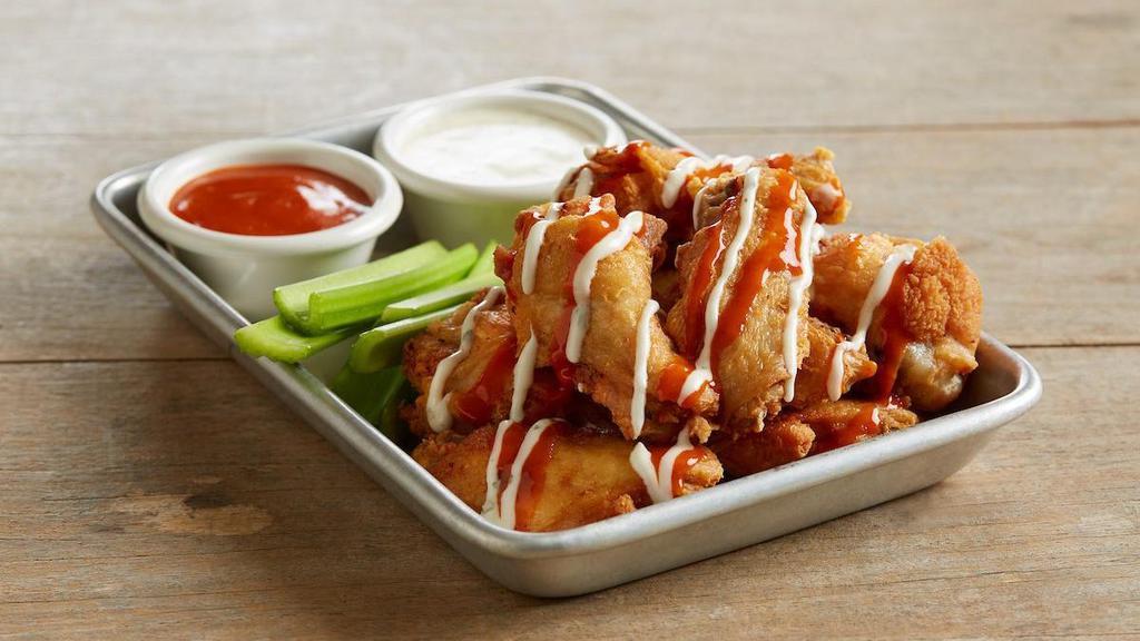 Bj'S Original Wings · Crispy, bone-in wings | drizzled with Hot and Spicy Buffalo sauce + ranch | extra sauce | served with celery sticks and ranch for dipping