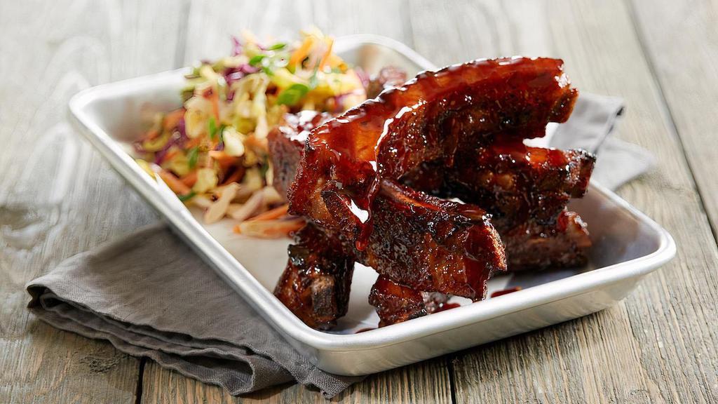 Root Beer Glazed Ribs · Five slow-roasted baby back pork ribs | BJ’s Handcrafted Root Beer glaze | spicy sriracha slaw | green onions