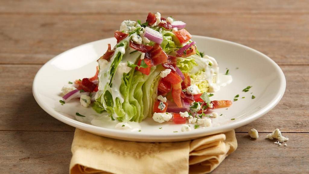 House Wedge Salad · Iceberg lettuce | bleu cheese crumbles | applewood smoked bacon | diced tomatoes | red onions | bleu cheese dressing