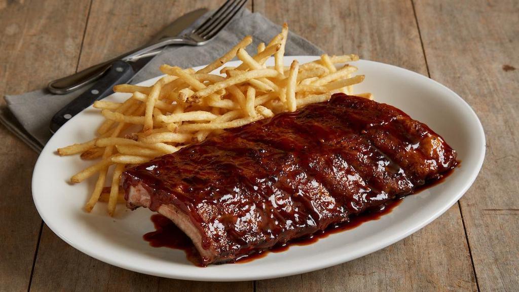 Baby Back Pork Ribs - Half · A half rack of slow-roasted overnight baby back ribs | Big Poppa Smokers’ Sweet Money Championship rub | BJ’s Peppered BBQ sauce | choice of two signature sides