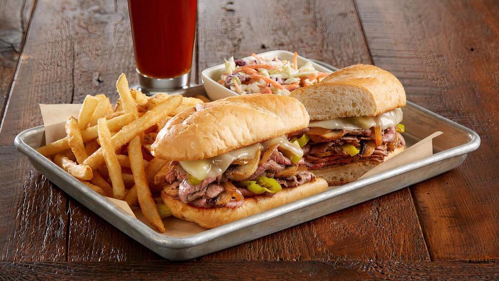 Brewhouse Philly* · Marinated, slow-roasted, sliced sirloin | provolone cheese | sautéed mushrooms | caramelized onions | green bell peppers | peperoncinis | toasted hoagie roll | side of BJ’s signature coleslaw | served with fries