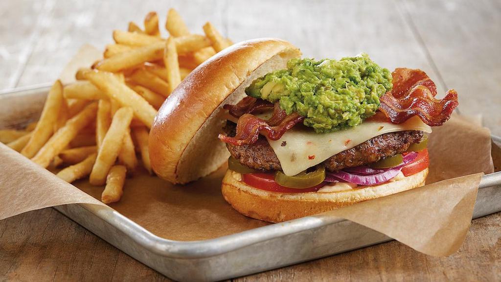 Bacon-Guacamole Deluxe Burger* · Fire-grilled beef patty | housemade guacamole | applewood smoked bacon | pepper jack cheese | chipotle mayonnaise | red onions | tomatoes | jalapeños | premium parker house bun