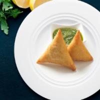 Famous Indian Samosa · Veg Samosa, India's favorite snack with green chutney and tomato ketchup.