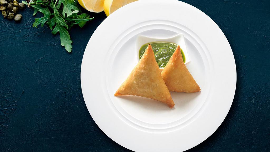 Famous Indian Samosa · Veg Samosa, India's favorite snack with green chutney and tomato ketchup.