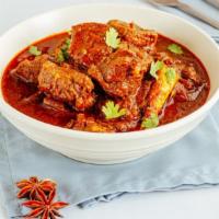 Goat Vindaloo · Fiery marinated Goat cooked in highly flavorful spicy mixture and vinegar