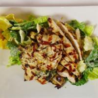 Caesar Salad · Petite hearts of romaine, baked parmesan cheese basket, croutons and homemade roasted garlic...