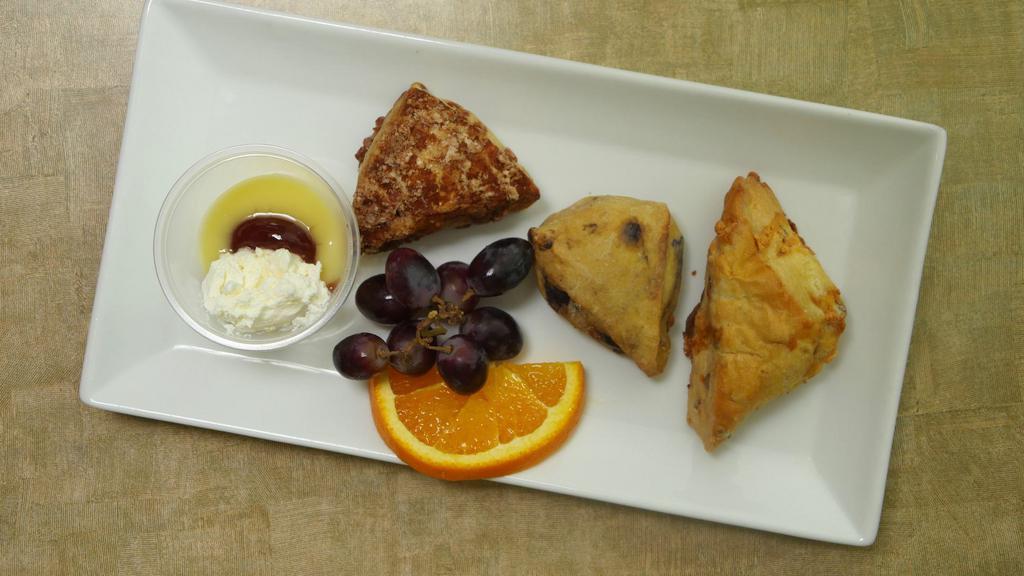 Set of 3 scones · Blueberry, Cinnamon, Raisins, or GF scone served with homemade clotted cream, lemon curd and jam