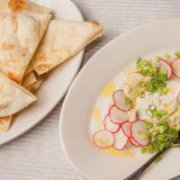 Hummus and Tahini · Green onion, radish, olive oil, tahini and house made flatbread.