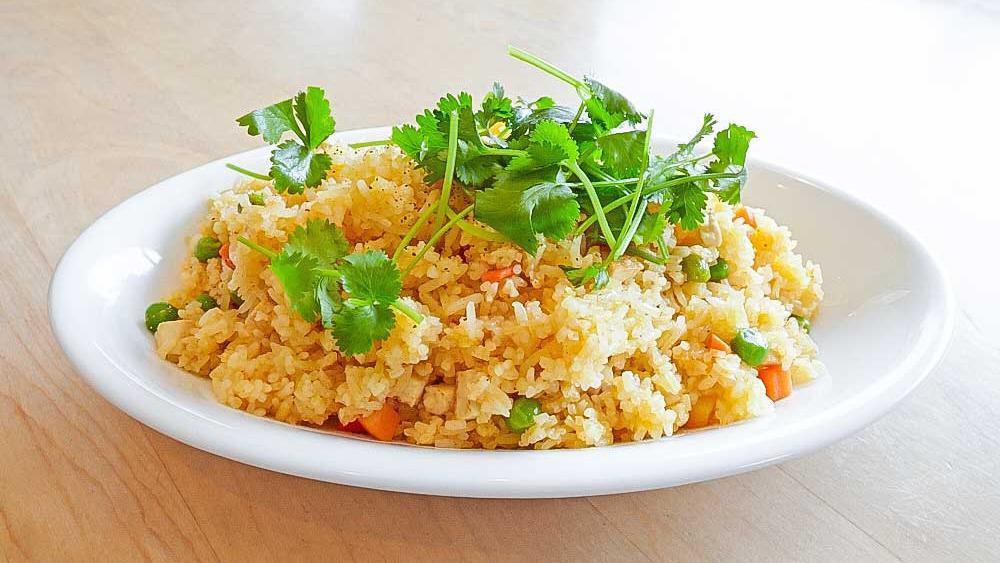 36. Gourmet Fried Rice / Com Chien · Stir-fried rice with tofu, carrot, and snow peas.