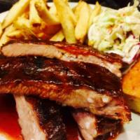 St. Louis Dry Rubbed Barbecue Pork Ribs · Smokey barbecue sauce, coleslaw, choice of barbecue beans or kennebec fries.