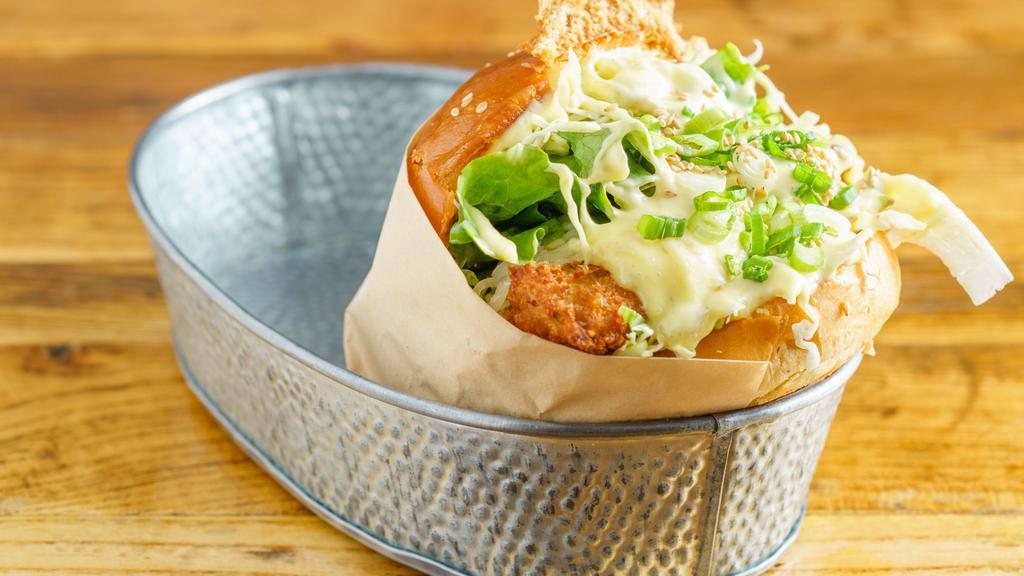 Fish Burger · Fish patty, cabbage salad, cheese, tartar sauce, and a tonkatsu sauce.